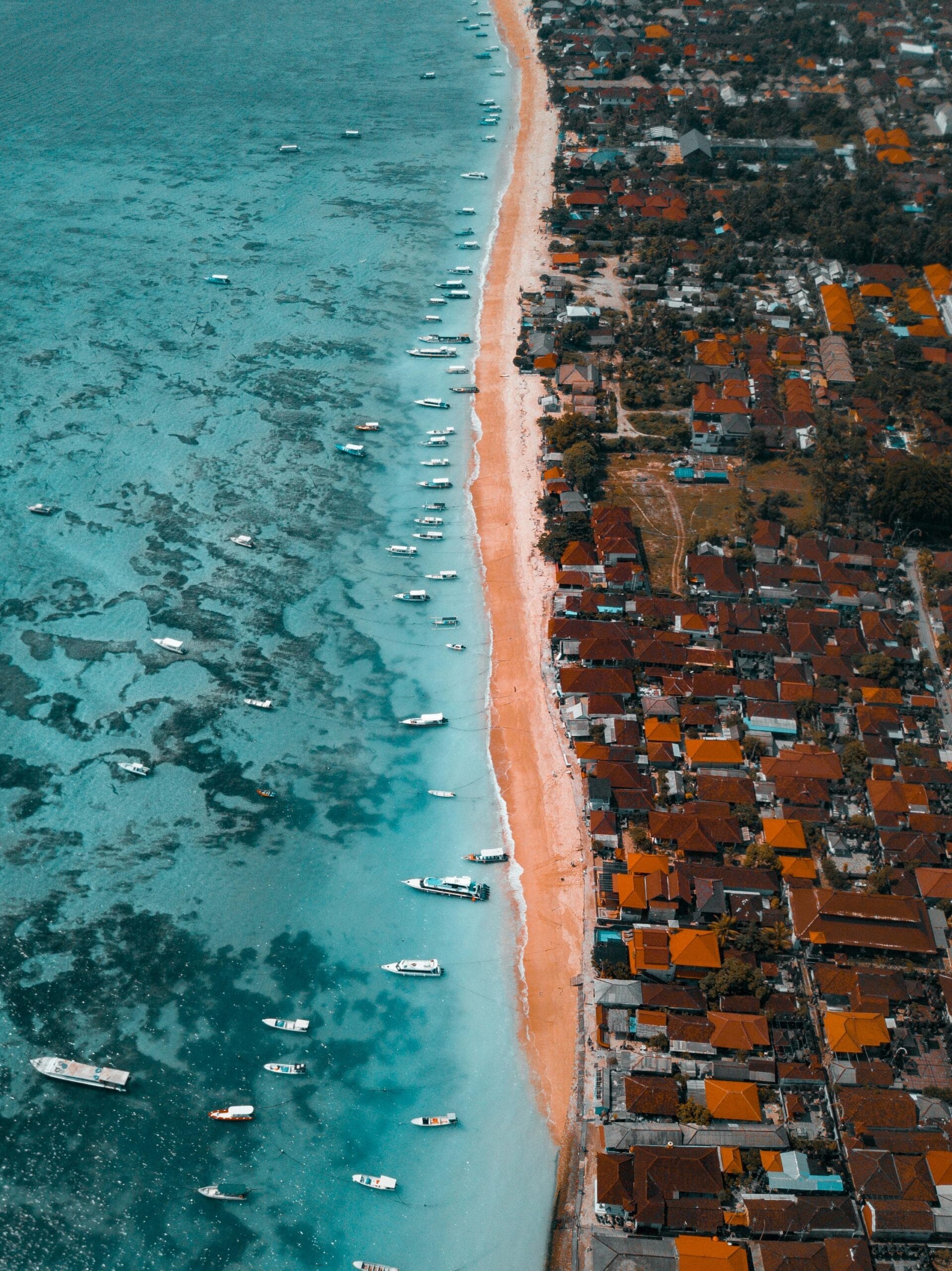 Aerial view of a sandy beach and coastal buildings in Bali