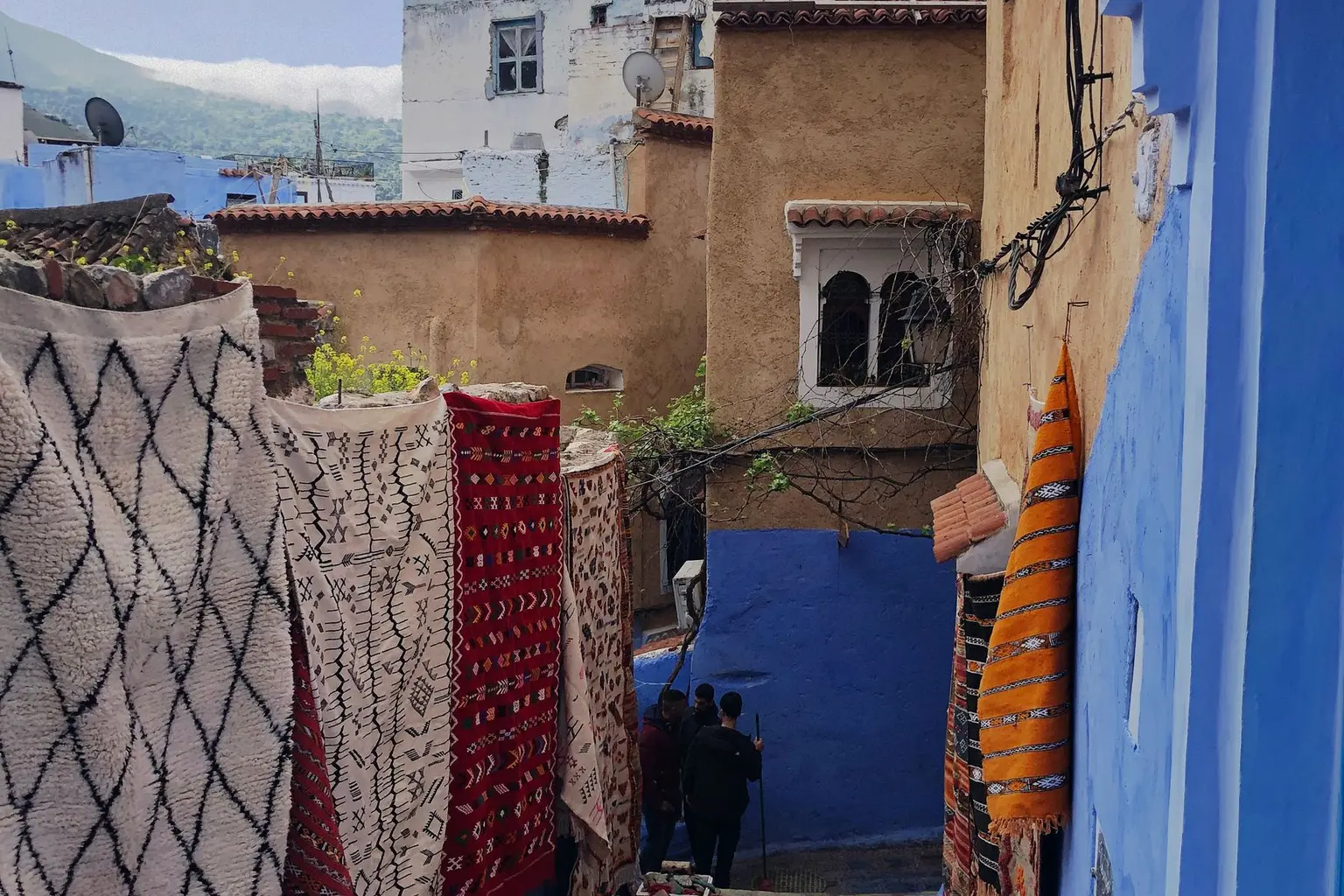 Traditional rugs in a blue Chefchaouen street
