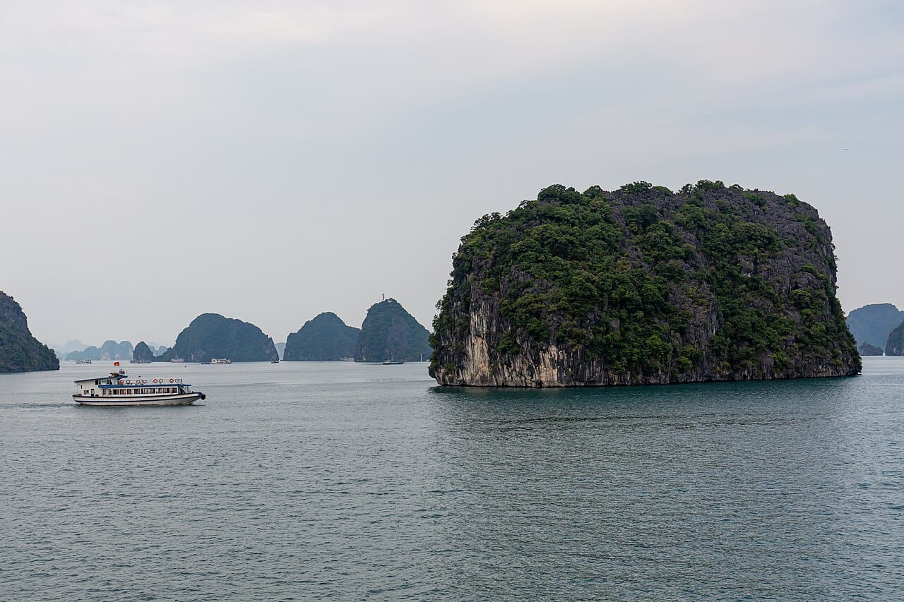 Passenger boat beside a limestone island in Ha Long Bay