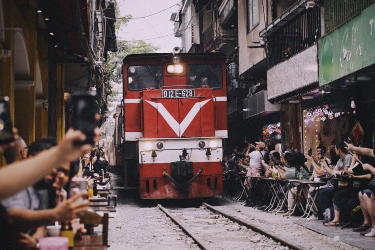 Red train on Hanoi Train Street before the journey to Da Nang