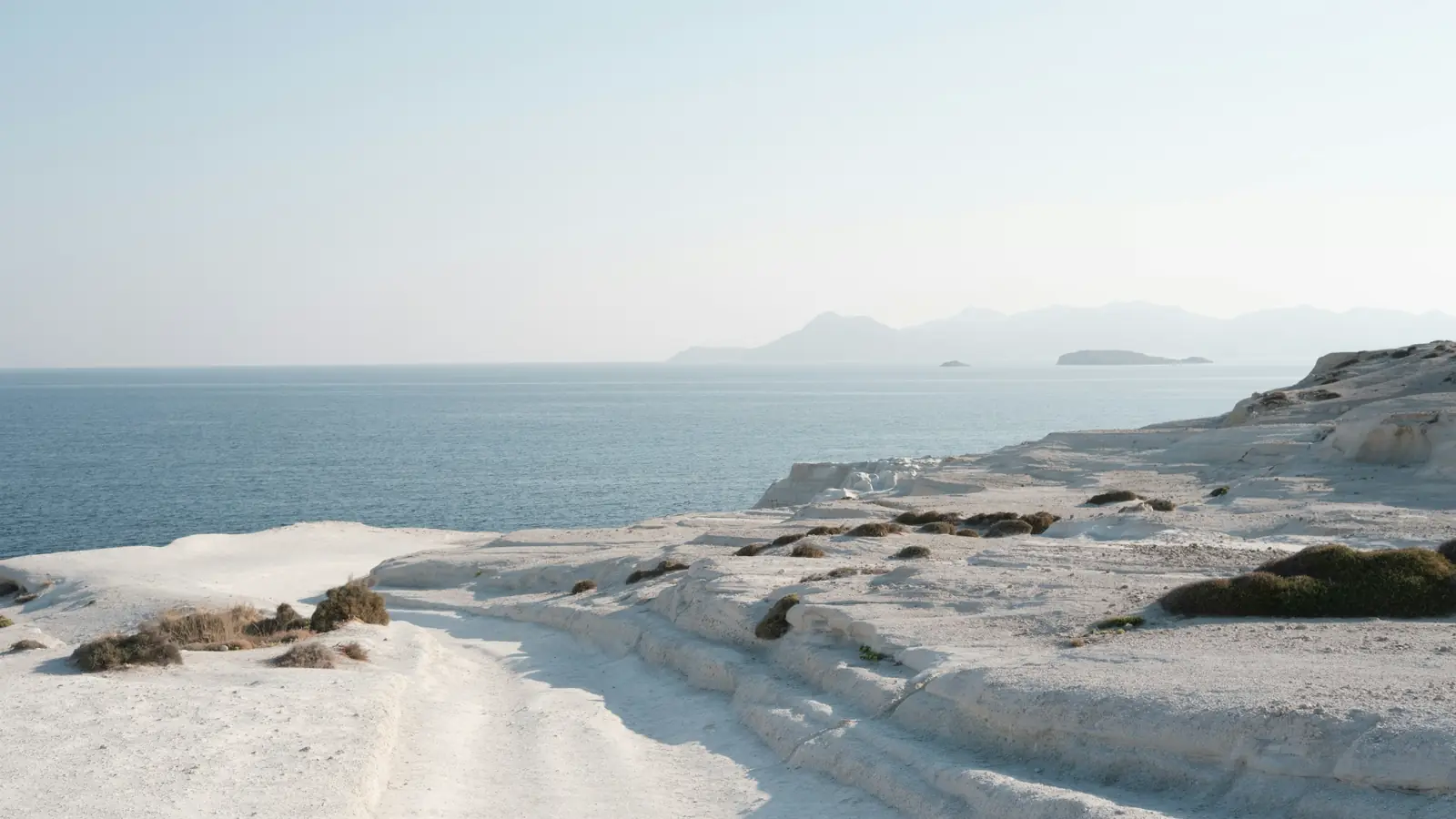 White volcanic cliffs and the Aegean Sea at Sarakiniko Beach in Milos