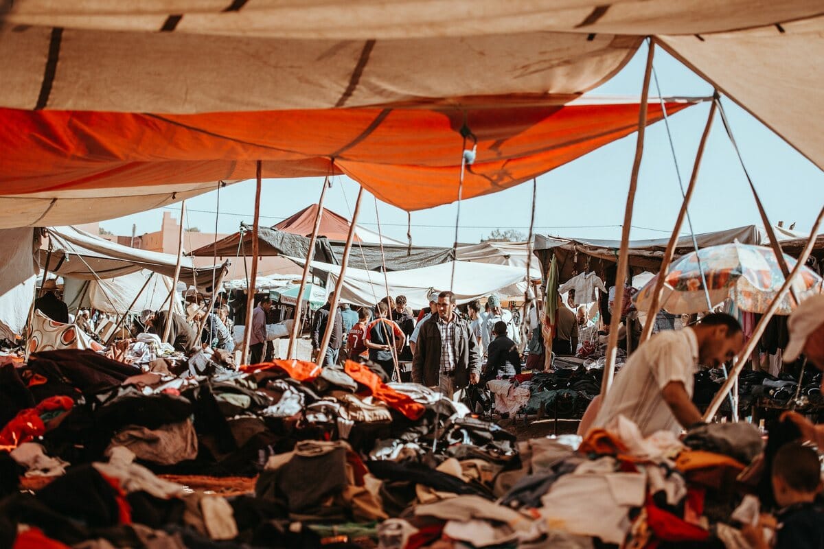 People speaking and shopping in a traditional market in Morocco