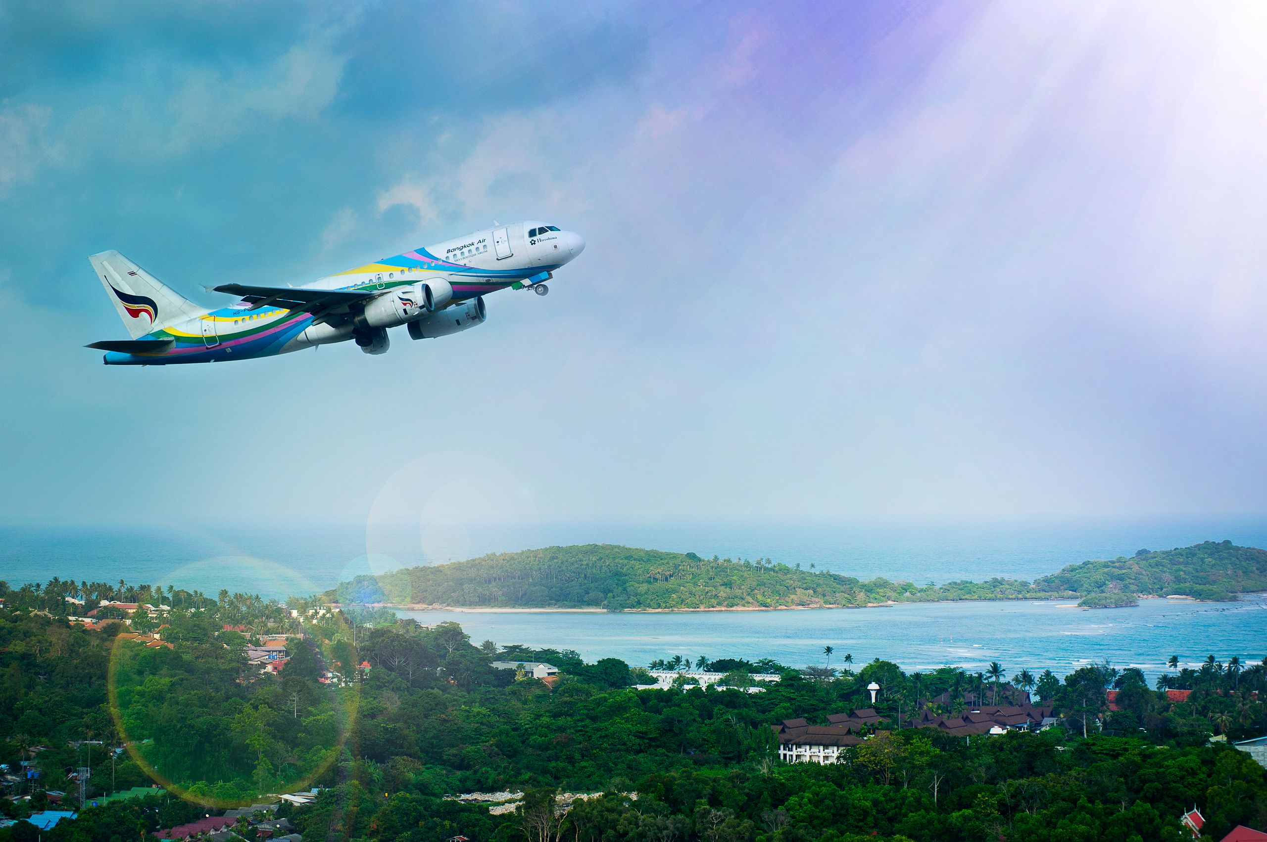Passenger airplane flying above the coast of Koh Samui, Thailand